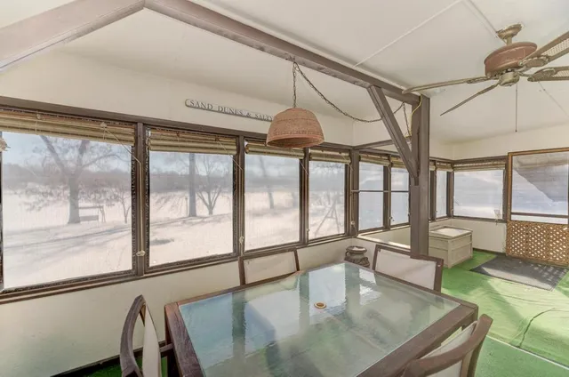 a view of dining room and livingroom with furniture wooden floor a chandelier