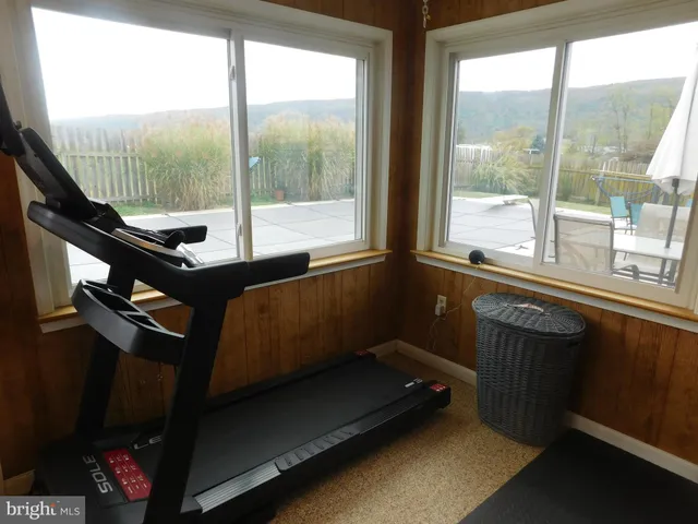 a bathroom with a granite countertop sink a toilet and a mirror