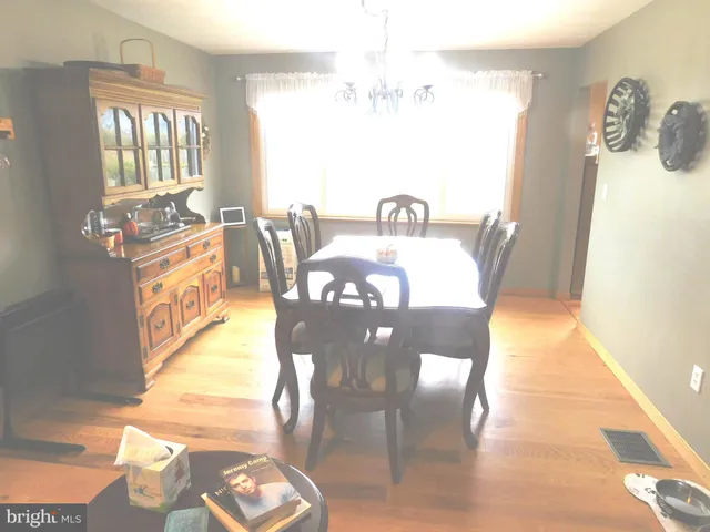 a view of a dining room with furniture and chandelier