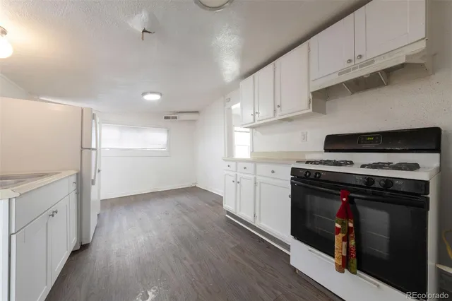 a kitchen with stainless steel appliances granite countertop a stove and a refrigerator
