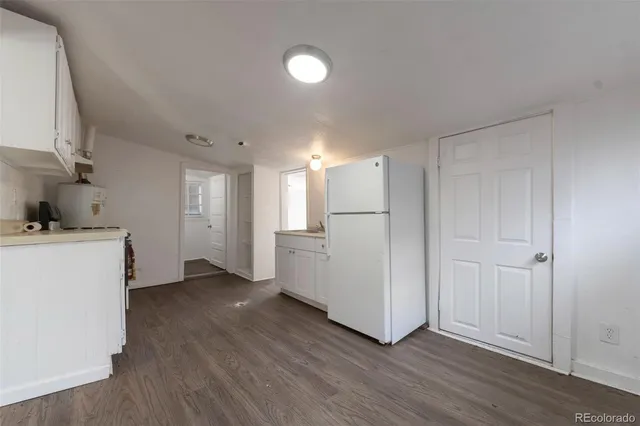 a view of a kitchen with wooden floor and a sink
