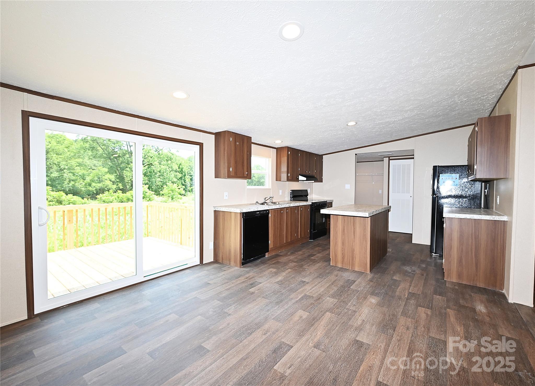 1187 Renno Road Clinton, SC 29325 - Photo 7 of 14 a kitchen with stainless steel appliances a refrigerator sink and wooden cabinets