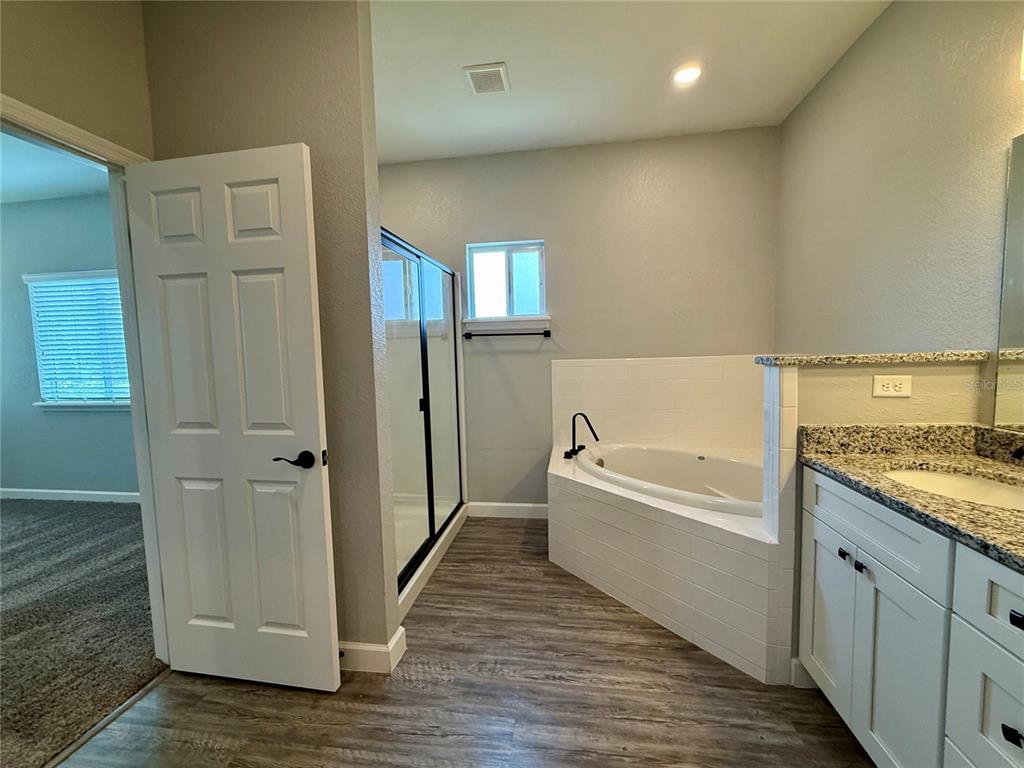 2653 Pine Place Winter Haven, FL 33881 - Photo 18 of 33 a bathroom with a tub shower and sink