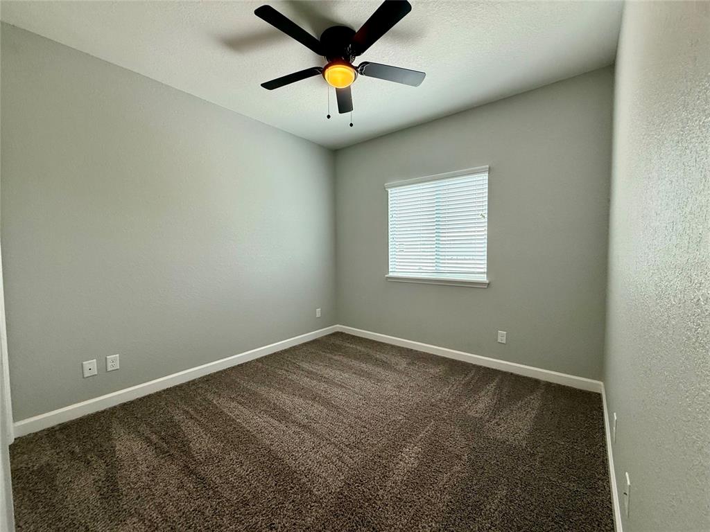 2653 Pine Place Winter Haven, FL 33881 - Photo 10 of 33 an empty room with a window and a ceiling fan
