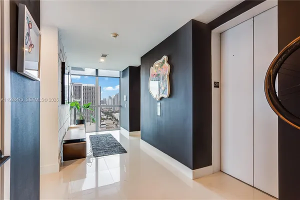 a hallway with mirror and furniture