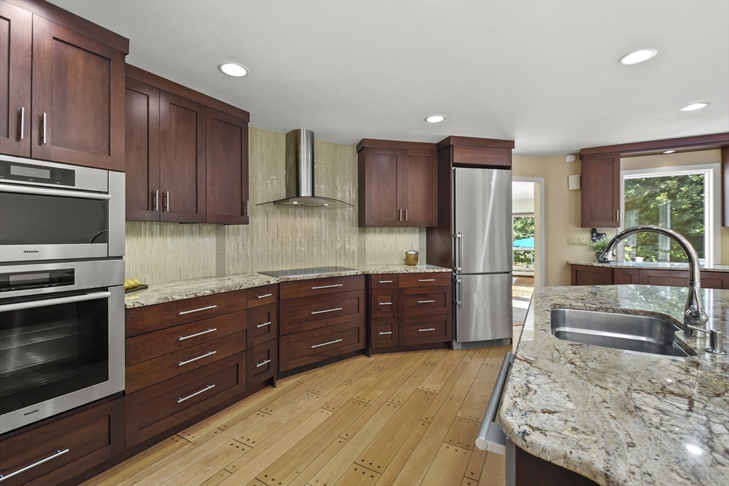 55 Prospect Hill Road Harvard, MA 01451 - Photo 8 of 42 a kitchen with stainless steel appliances granite countertop wooden cabinets a stove top oven a sink and dishwasher