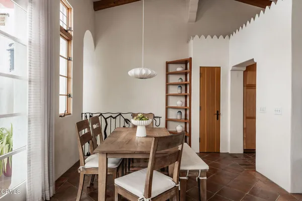 a view of a dining room with furniture and window