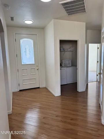 an empty room with wooden floor and closet