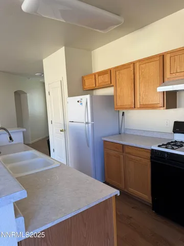 a kitchen with refrigerator and cabinets