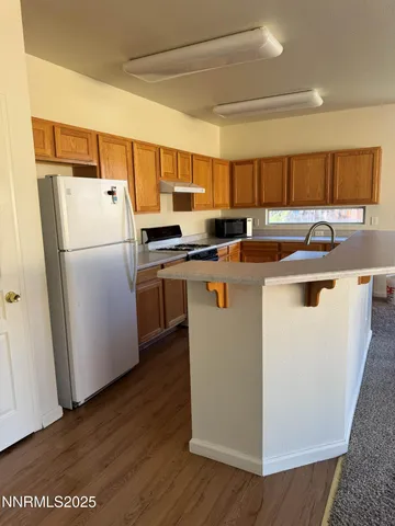a kitchen with appliances a sink a counter space and cabinets