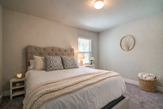 a bedroom with a bed and a chandelier
