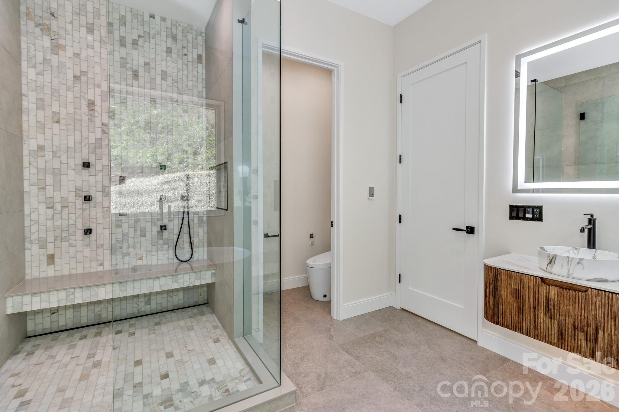 134 View Ridge Parkway Leicester, NC 28748 - Photo 28 of 48 a bathroom with a tub shower and sink