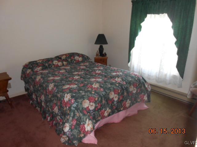 124 Rolling View Road Palmerton, PA 18071 - Photo 7 of 15 a bed sitting in a bedroom next to a window