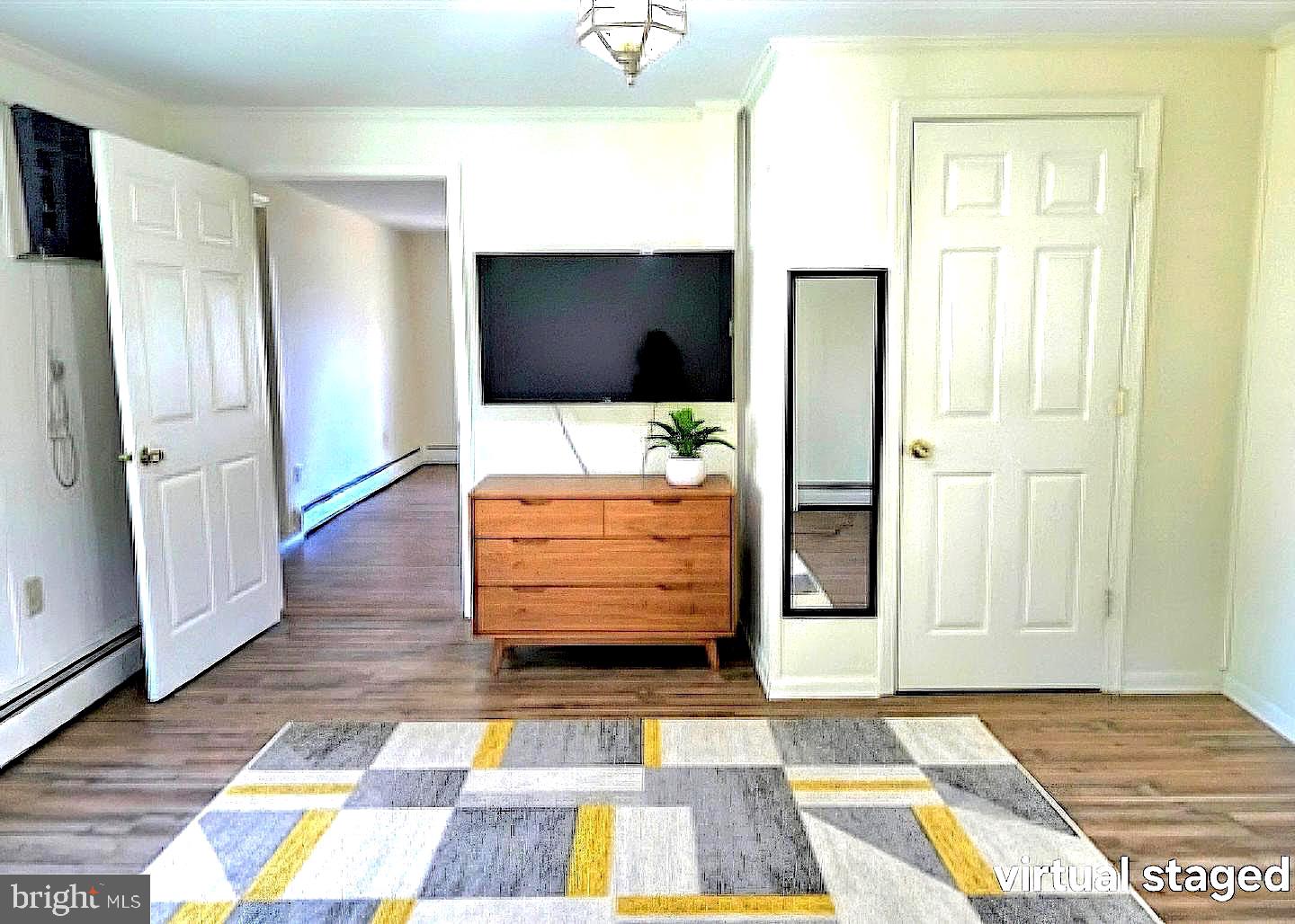 405 Leonards Lane Cambridge, MD 21613 - Photo 14 of 33 a living room with a rug and a flat screen tv