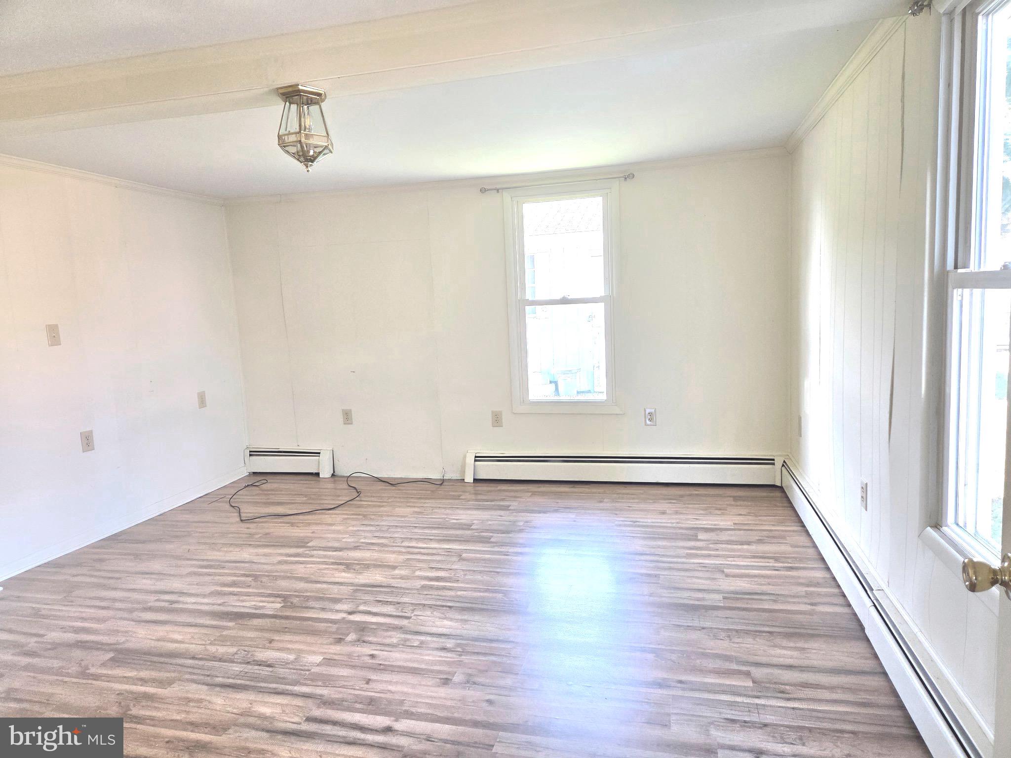 405 Leonards Lane Cambridge, MD 21613 - Photo 15 of 33 a view of empty room with wooden floor and fan