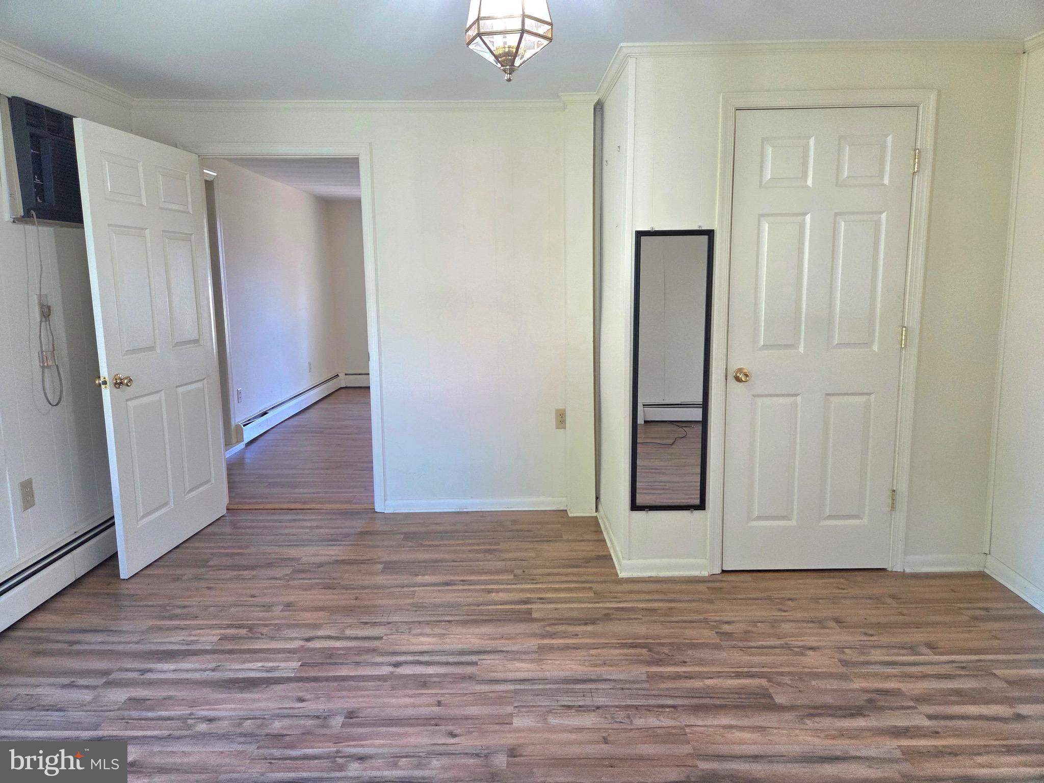 405 Leonards Lane Cambridge, MD 21613 - Photo 16 of 33 a view of an empty room with wooden floor and a window