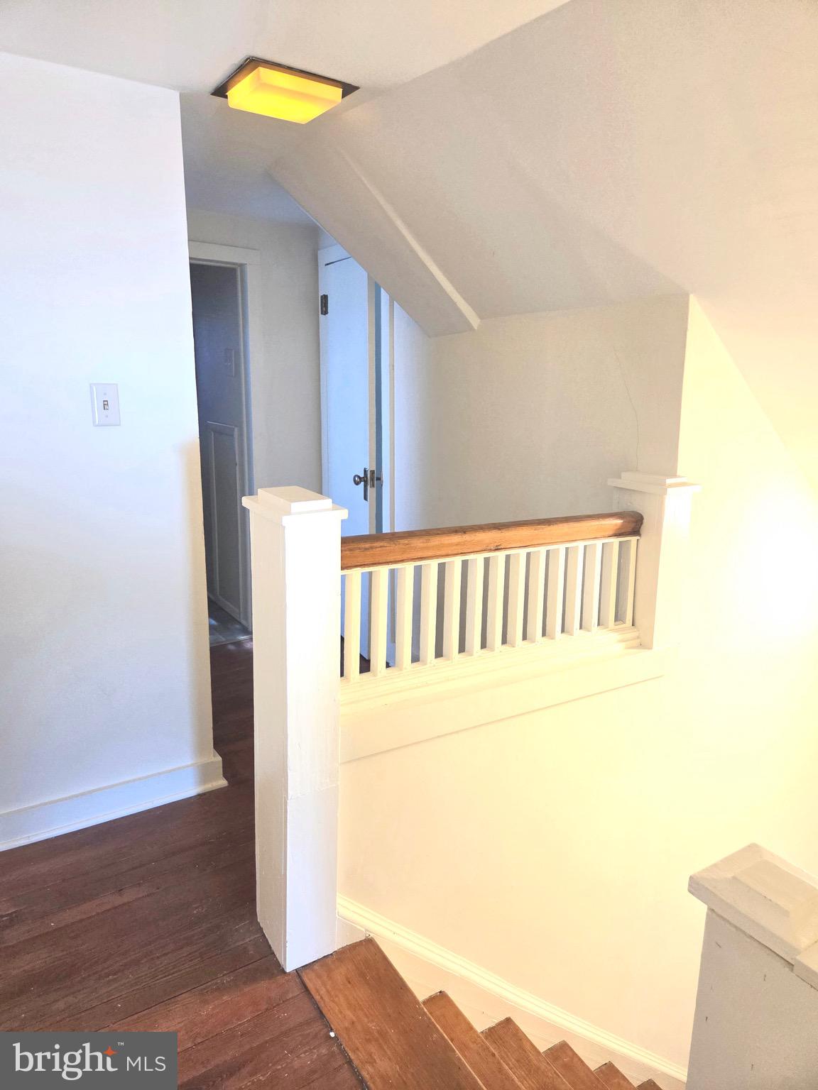 405 Leonards Lane Cambridge, MD 21613 - Photo 21 of 33 a view of a hallway to a bedroom with wooden floor and a bathroom
