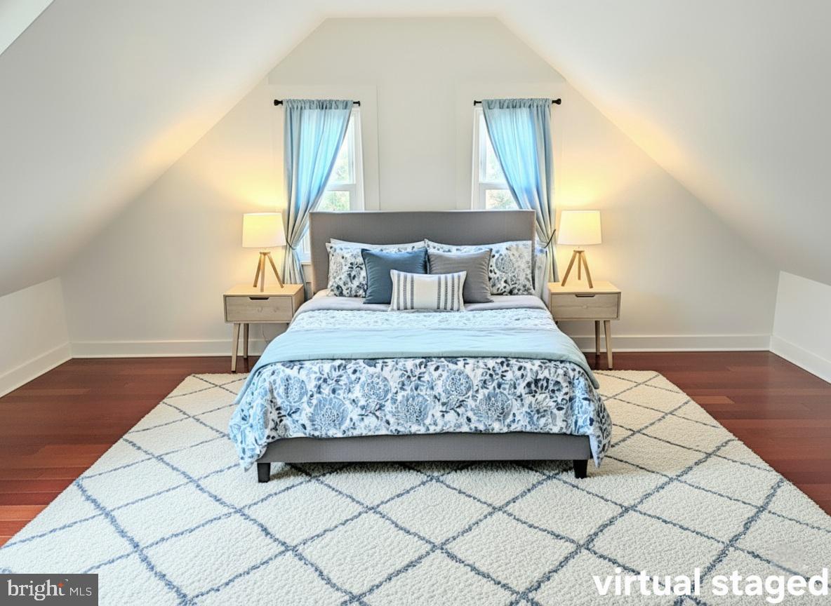 405 Leonards Lane Cambridge, MD 21613 - Photo 23 of 33 a bedroom with a large bed and a wooden floor