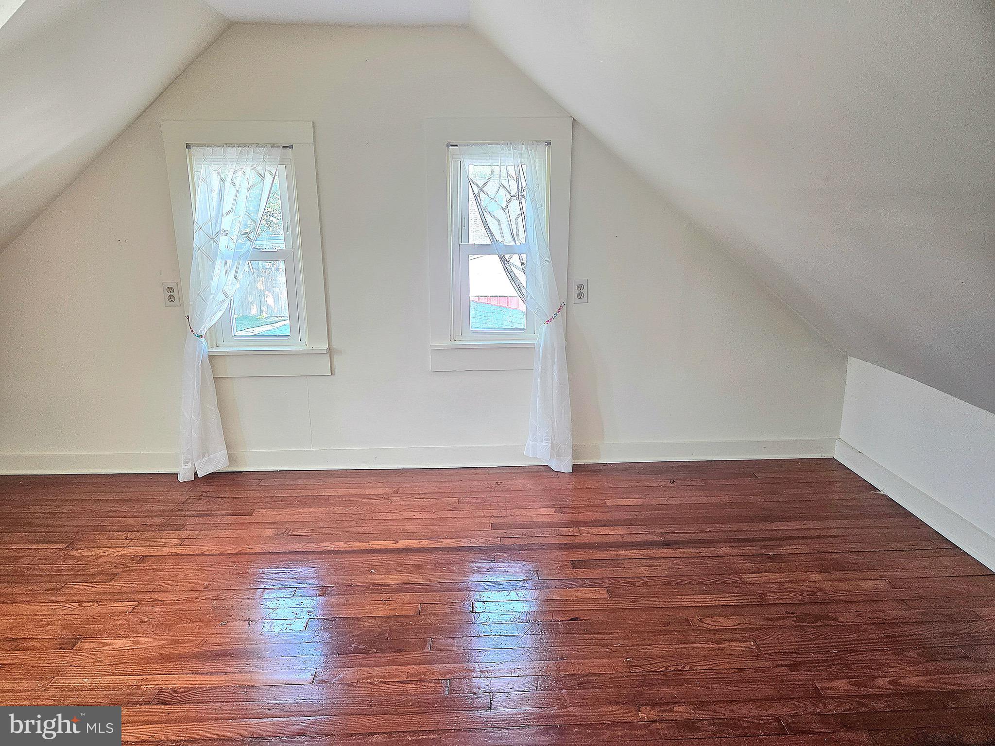 405 Leonards Lane Cambridge, MD 21613 - Photo 24 of 33 a view of an empty room with wooden floor and a window