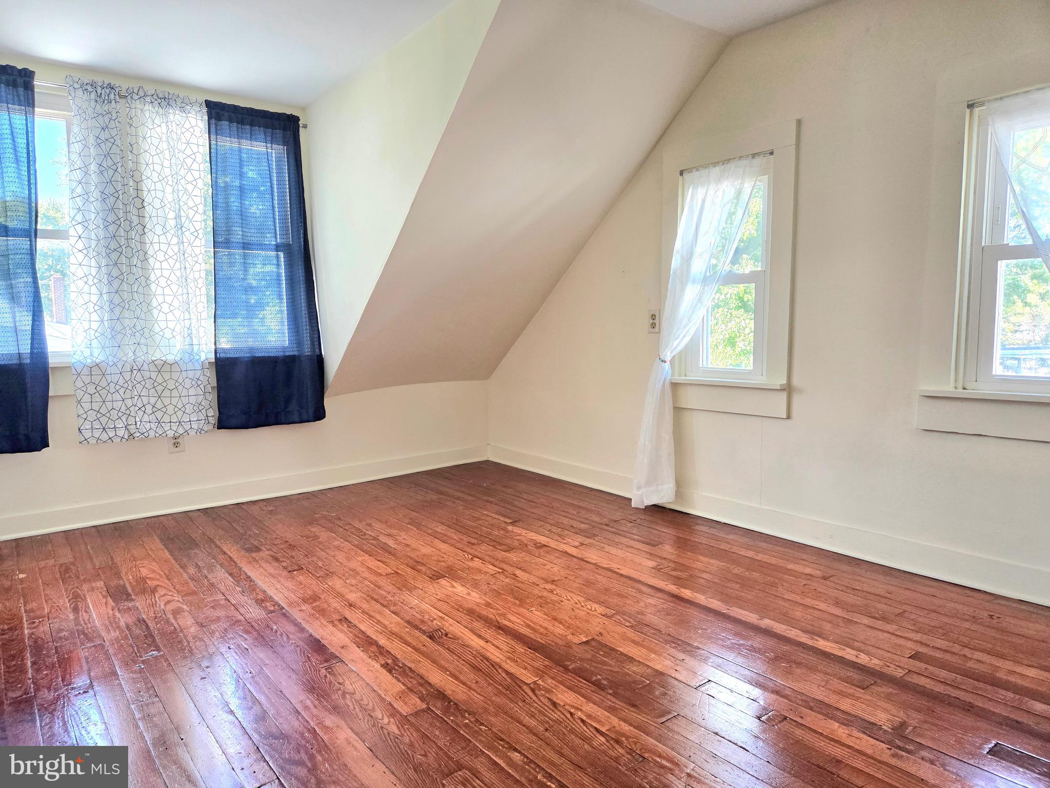 405 Leonards Lane Cambridge, MD 21613 - Photo 25 of 33 an empty room with wooden floor and windows