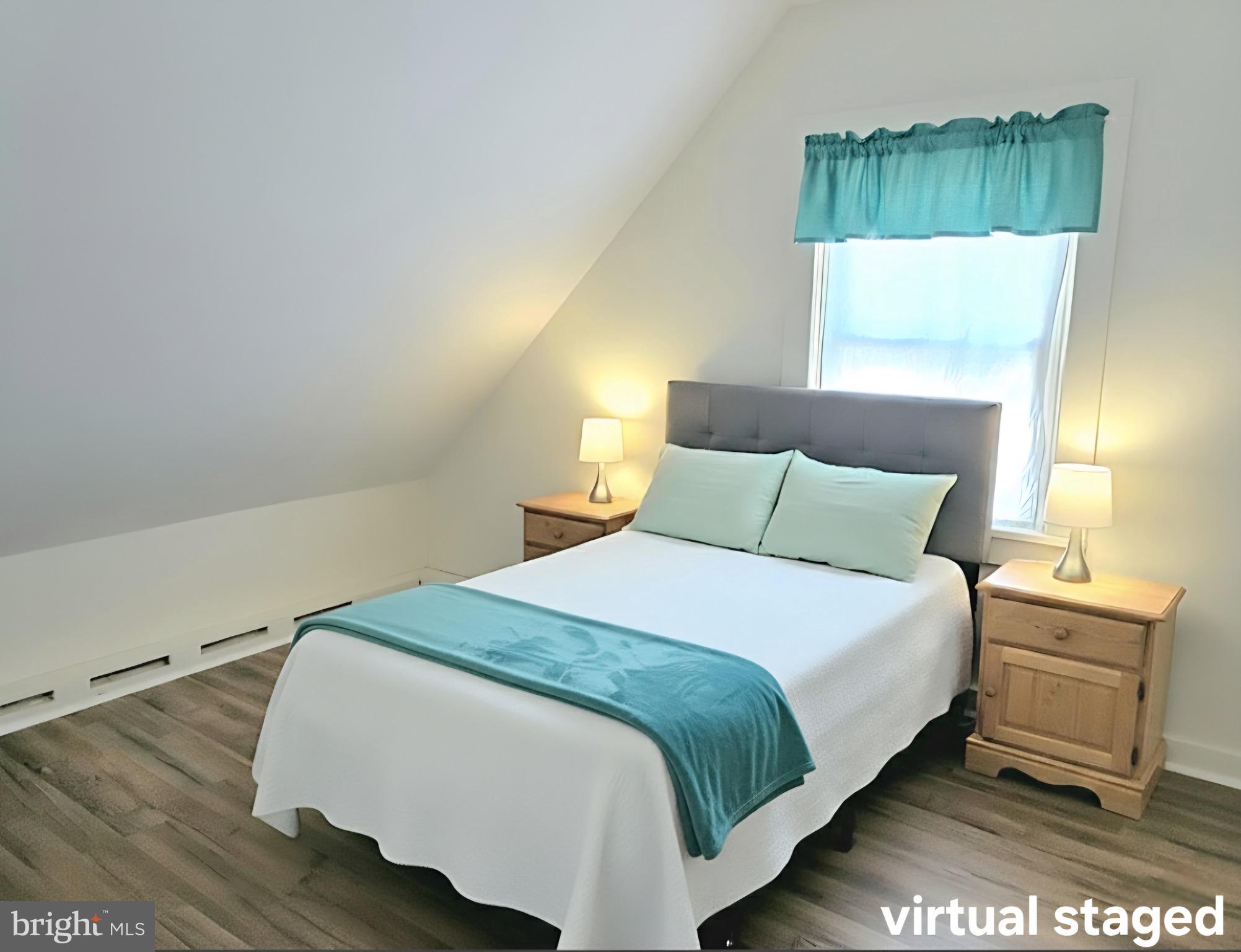 405 Leonards Lane Cambridge, MD 21613 - Photo 28 of 33 a bedroom with a bed and a lamp