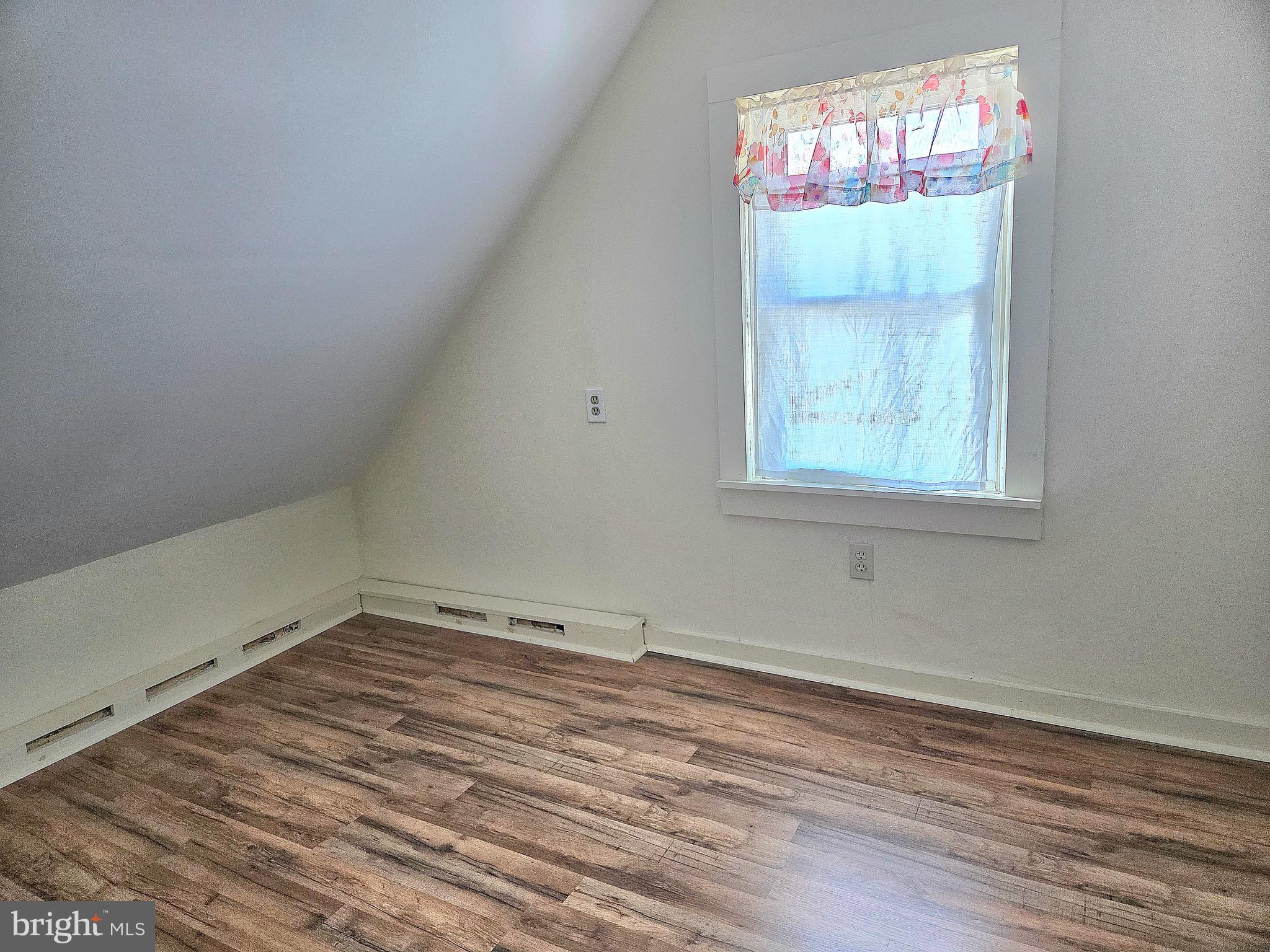 405 Leonards Lane Cambridge, MD 21613 - Photo 29 of 33 an empty room with wooden floor and windows