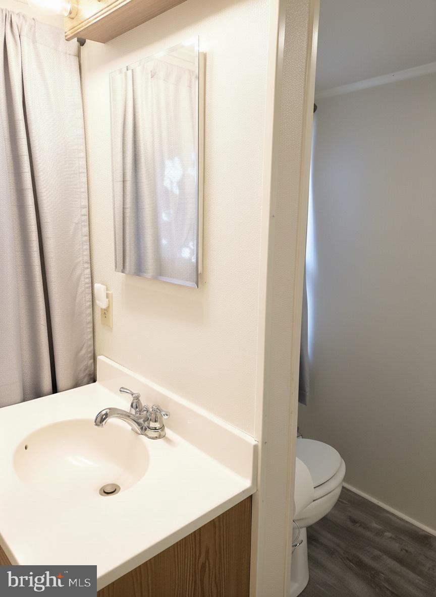 405 Leonards Lane Cambridge, MD 21613 - Photo 31 of 33 a bathroom with a sink and a toilet