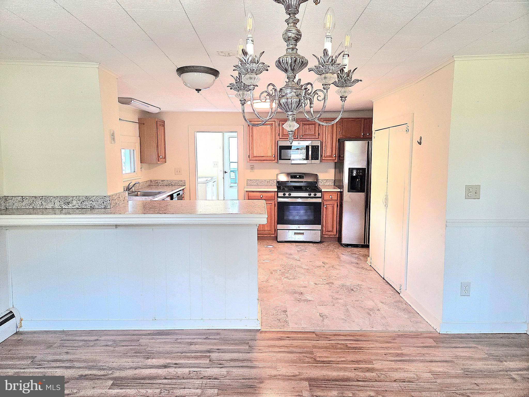 405 Leonards Lane Cambridge, MD 21613 - Photo 6 of 33 a living room with kitchen island granite countertop furniture and a fireplace