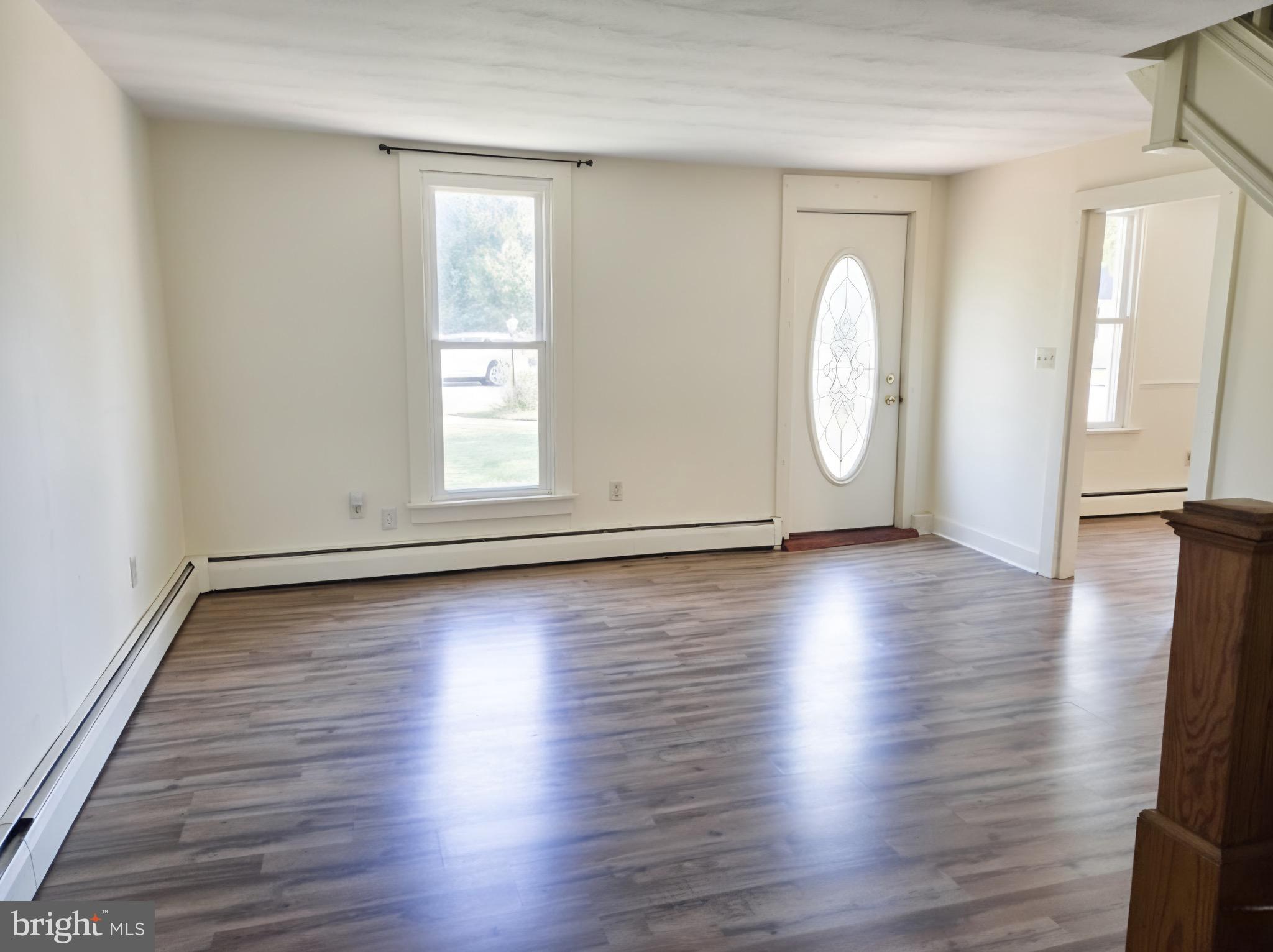 405 Leonards Lane Cambridge, MD 21613 - Photo 9 of 33 an empty room with wooden floor and windows