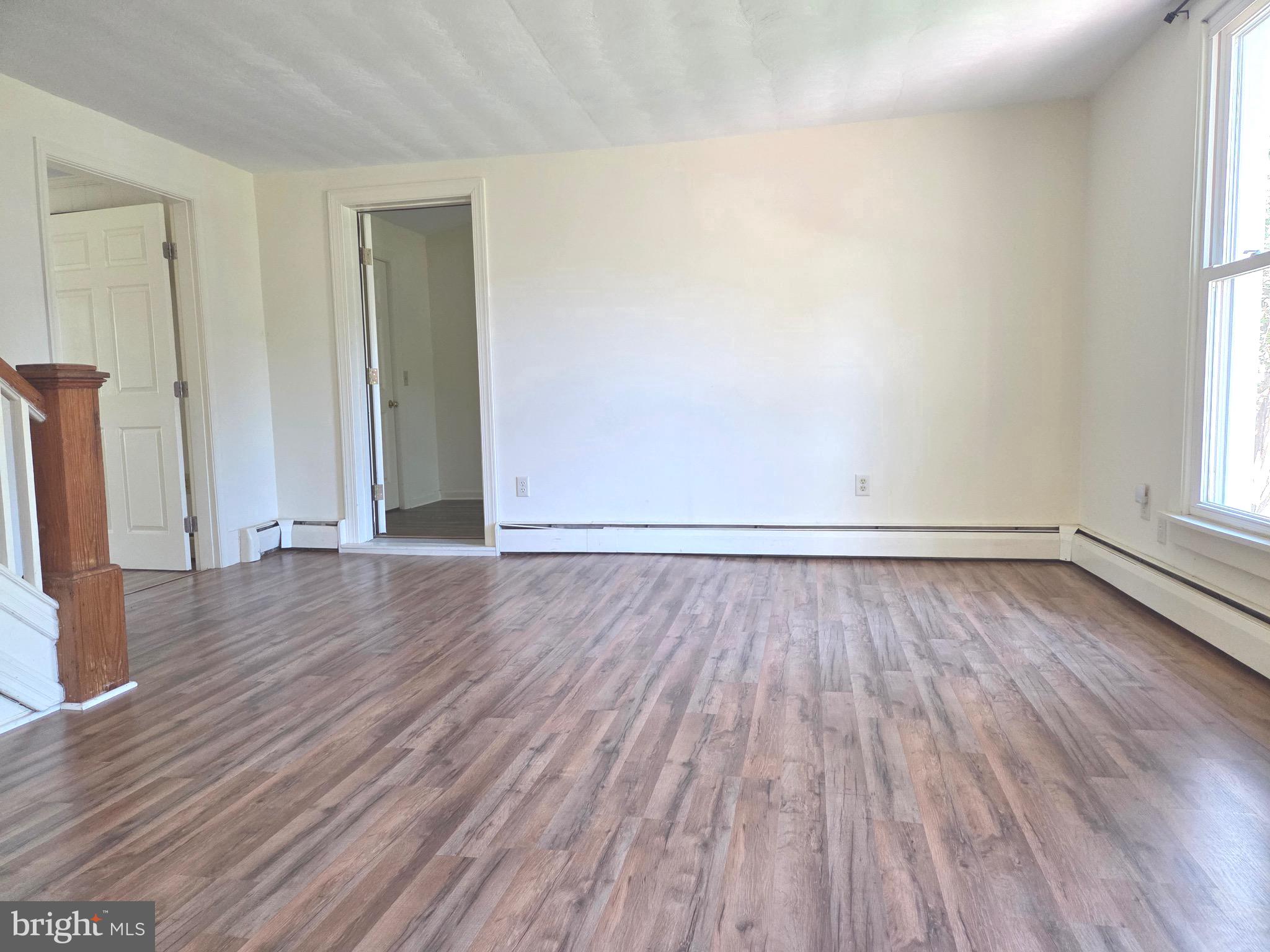 405 Leonards Lane Cambridge, MD 21613 - Photo 10 of 33 an empty room with wooden floor and windows
