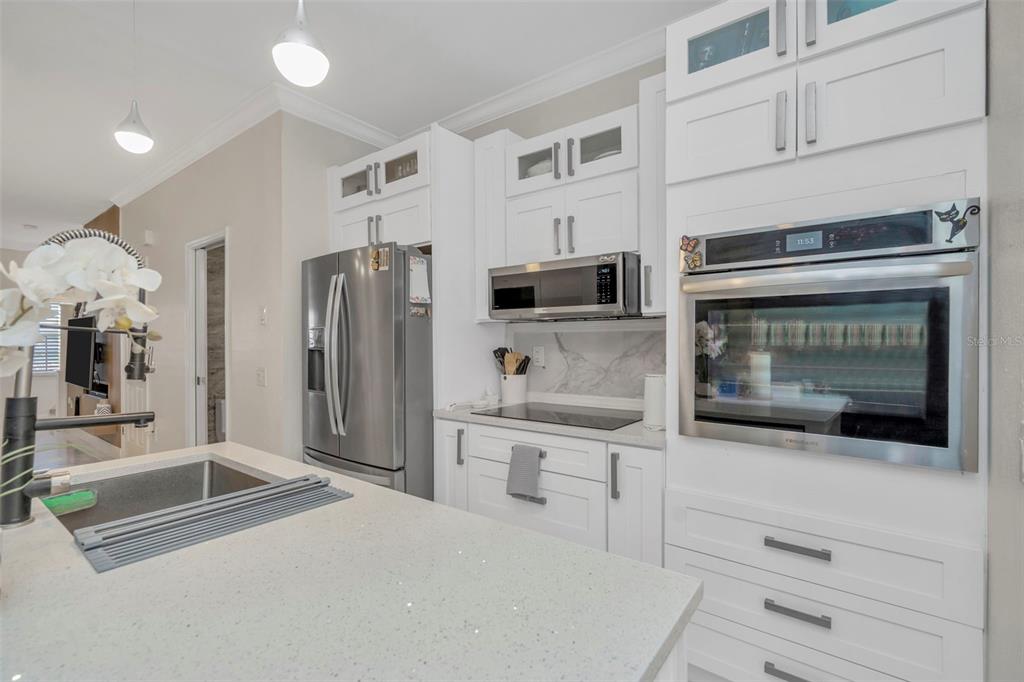 6765 Lake Rochester Lane Gibsonton, FL 33534 - Photo 13 of 33 a kitchen with stainless steel appliances a refrigerator and a stove top oven