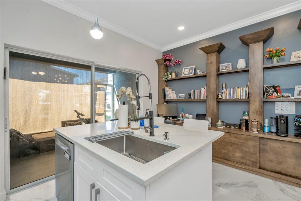 6765 Lake Rochester Lane Gibsonton, FL 33534 - Photo 15 of 33 a kitchen with stainless steel appliances a sink a stove and a refrigerator with wooden floor