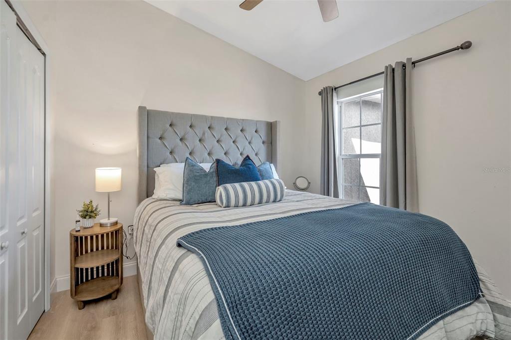 6765 Lake Rochester Lane Gibsonton, FL 33534 - Photo 19 of 33 a bedroom with a bed and a window