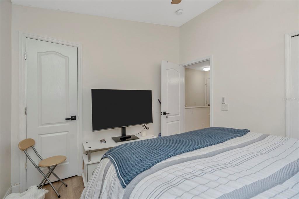 6765 Lake Rochester Lane Gibsonton, FL 33534 - Photo 21 of 33 a bedroom with a bed and a flat screen tv