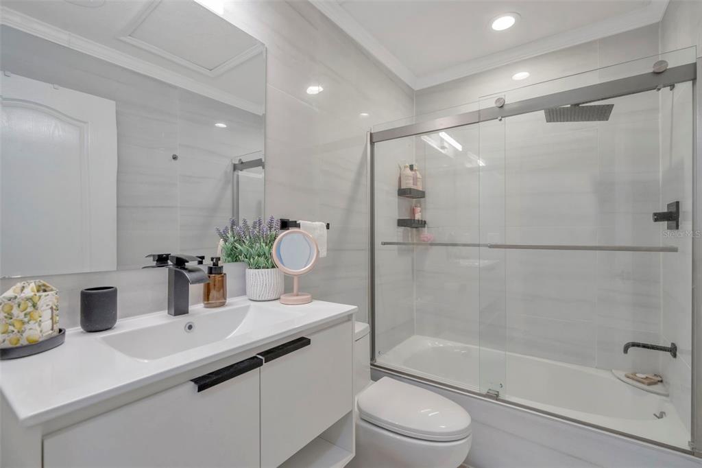 6765 Lake Rochester Lane Gibsonton, FL 33534 - Photo 22 of 33 a bathroom with a sink a toilet and shower