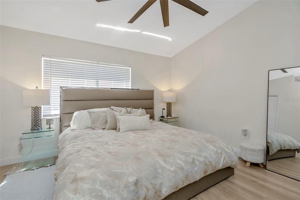 6765 Lake Rochester Lane Gibsonton, FL 33534 - Photo 23 of 33 a bedroom with a bed and a ceiling fan