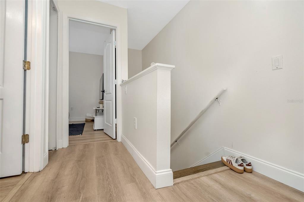 6765 Lake Rochester Lane Gibsonton, FL 33534 - Photo 26 of 33 a view of a room with wooden floor and staircase