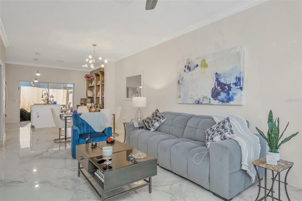 6765 Lake Rochester Lane Gibsonton, FL 33534 - Photo 3 of 33 a living room with furniture and a chandelier