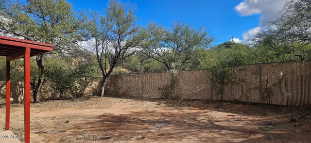 a view of a barn with a large tree