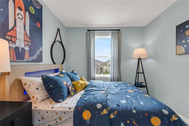 a bedroom with a bed and a chandelier