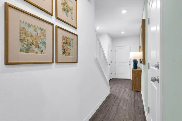 a view of a hallway with wooden floor and entryway
