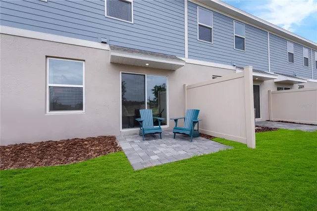 a view of an house with backyard space and balcony