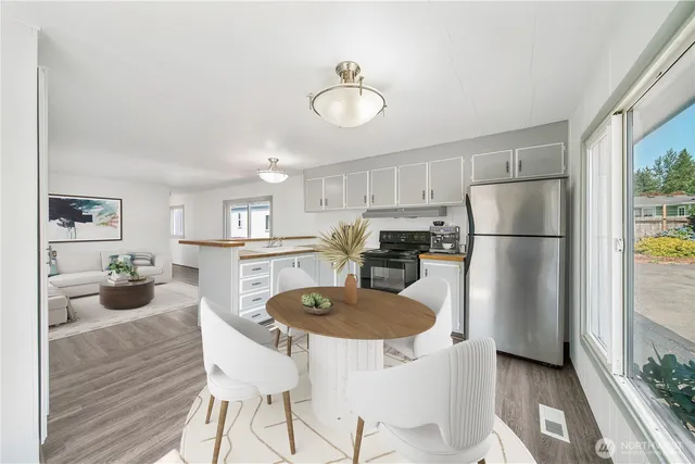 a kitchen with refrigerator and furniture