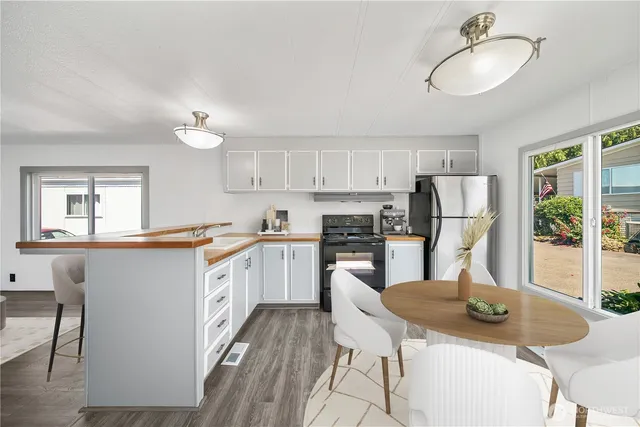 a kitchen with refrigerator cabinets and wooden floor