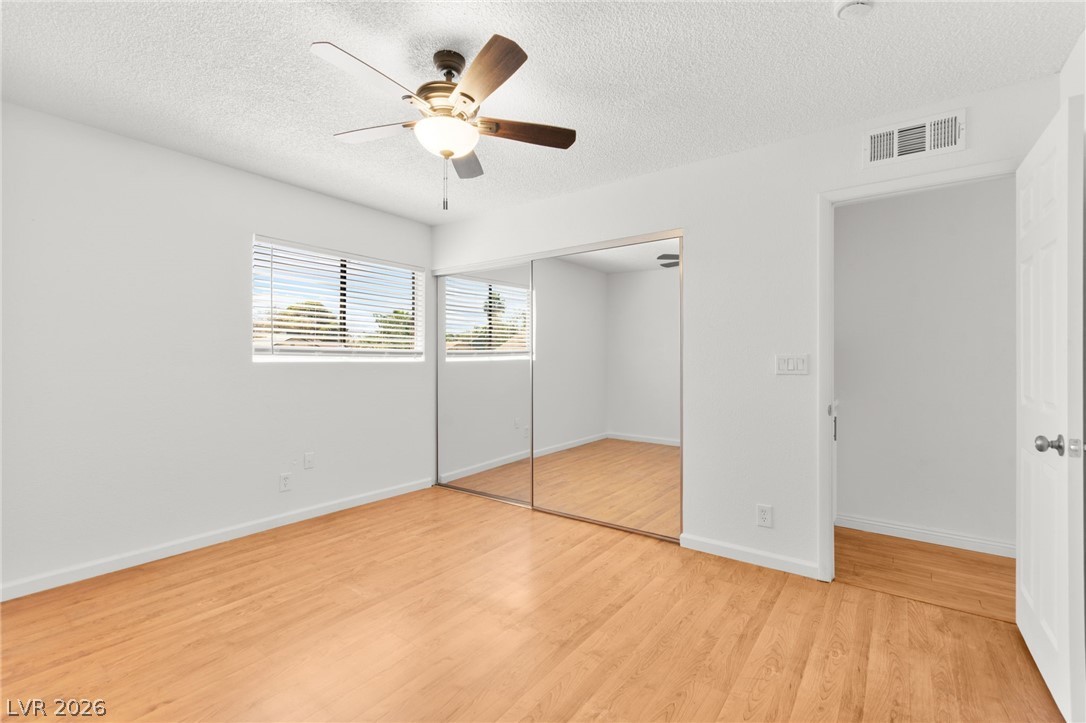 4430 Cranbrook Way Las Vegas, NV 89103 - Photo 42 of 50 Hardwood floors and a ceiling fan create a comfortable atmosphere in this well-lit room.