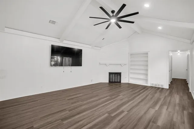 wooden floor in an empty room with a fireplace