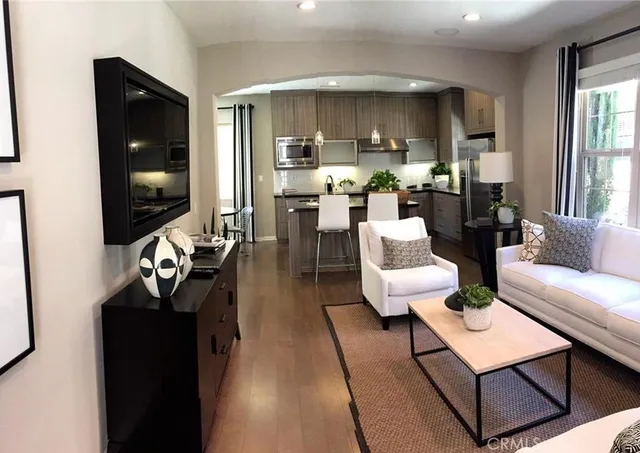 a living room with furniture and wooden floor