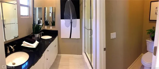 a bathroom with a toilet mirror and a shower