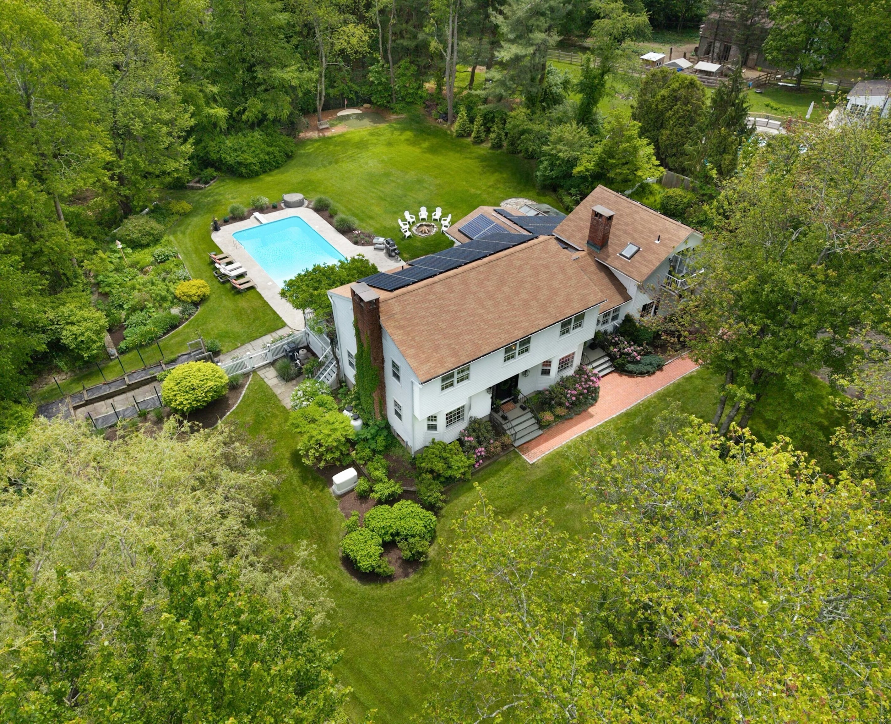 an aerial view of a house with garden space and street view