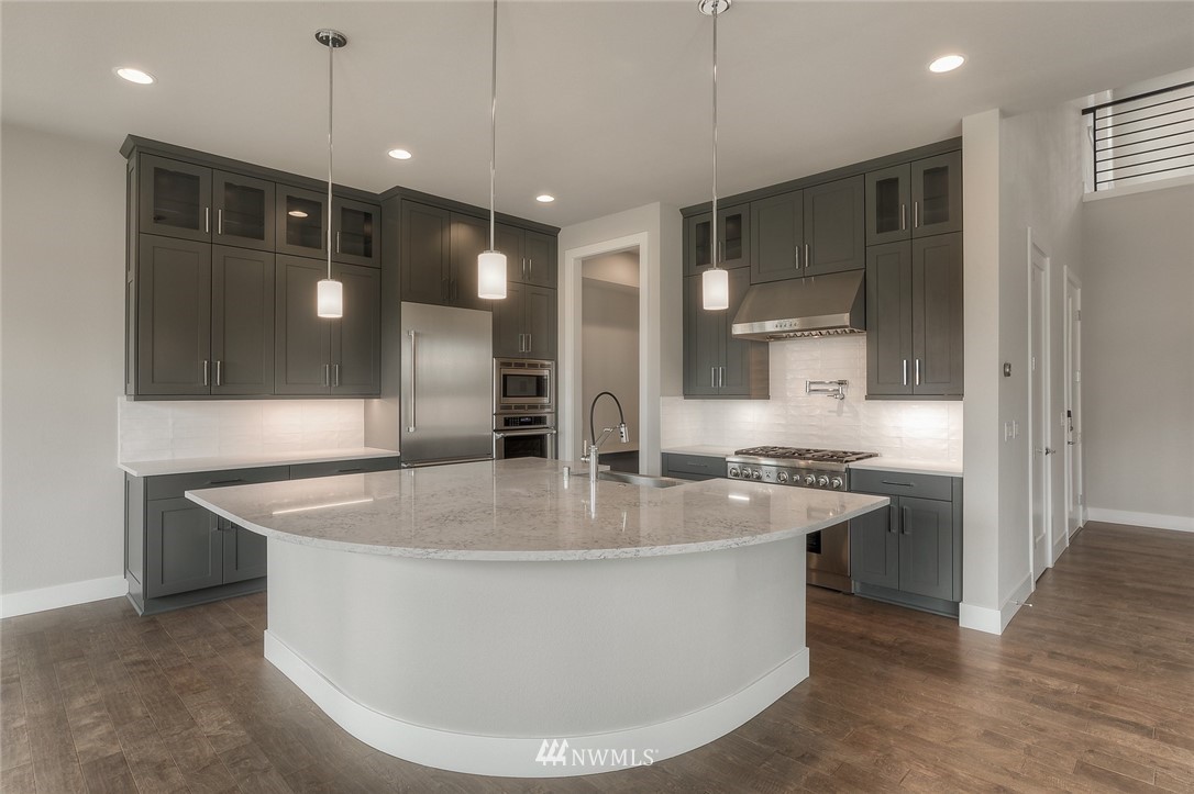 3317 219th Place Southeast, Unit 30 Bothell, WA 98021 - Photo 12 of 25 a large kitchen with kitchen island a sink and a refrigerator